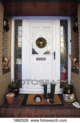 Rain Boots On The Mat Outside A Front Door; South Shields, Tyne And Wear, England View Large Photo Image Stock Photo - Rain Boots On The Mat Outside A Front Door; South Shields, Tyne And Wear, England. Fotosearch