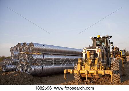 Road Construction Using A Grader And A Bundle Of Culvert Pipes; Edmonton, Alberta, Canada View Large Photo Image Stock Photograph - Road Construction Using A Grader And A Bundle Of Culvert Pipes; Edmonton, Alberta, Canada. Fotosearch