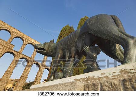 Statue Of A She-Wolf Suckling Romulus And Remus With The Roman Aqueduct In The Background; Segovia, Segovia Province, Spain View Large Photo Image Stock Photograph - Statue Of A She-Wolf Suckling Romulus And Remus With The Roman Aqueduct In The Background; Segovia, Segovia Province, Spain. Fotosearch