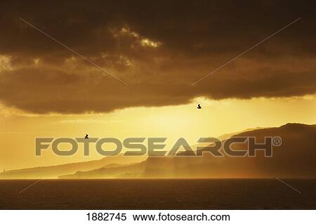Stock Photography - Sun Breaking Through The Dark Clouds; Tarifa, Cadiz, Andalusia, Spain. Fotosearch