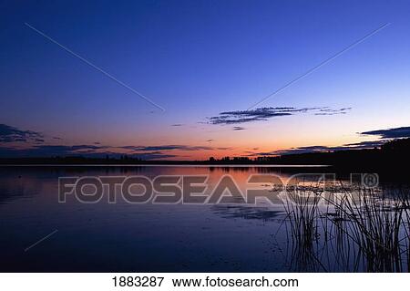 Sunset Over Lake Wabamun With Grasses In The Foreground; Wabamun, Alberta, Canada View Large Photo Image Stock Photo - Sunset Over Lake Wabamun With Grasses In The Foreground; Wabamun, Alberta, Canada. Fotosearch