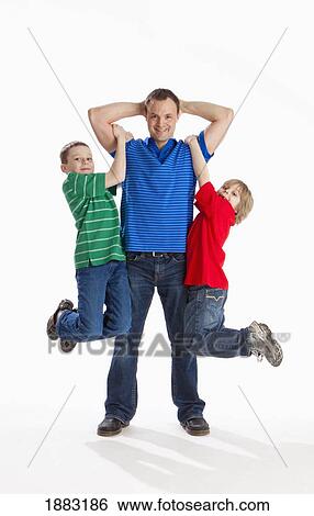 Two Boys Hanging From Their Father's Arms View Large Photo Image Stock Photograph - Two Boys Hanging From Their Father's Arms. Fotosearch