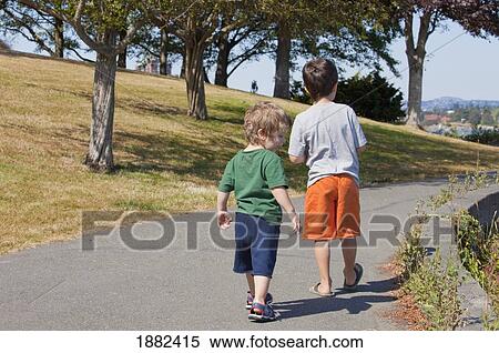 Two Boys Walking On A Trail; Langley, British Columbia, Canada View Large Photo Image Stock Photography - Two Boys Walking On A Trail; Langley, British Columbia, Canada. Fotosearch
