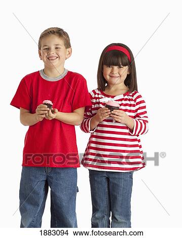Two Children Wearing Red And Holding Cupcakes View Large Photo Image Picture - Two Children Wearing Red And Holding Cupcakes. Fotosearch