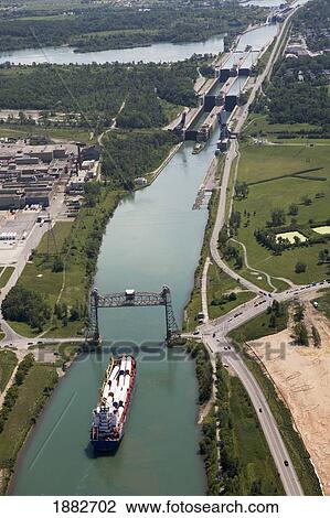 Welland Canal With A Ship, Bridge And Locks; Thorold, Ontario, Canada View Large Photo Image Stock Image - Welland Canal With A Ship, Bridge And Locks; Thorold, Ontario, Canada. Fotosearch