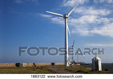 Stock Image - Wind Turbines On A Pier Along The Coast; Blyth, Northumberland, England. Fotosearch
