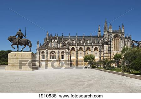 Stock Photo - 14th century monastery of santa maria of victoria, better known as batalha (battle abbey) with monument to nvno alvares pereira (1360 - 1431) in the foreground; batalha, estremadura and ribatejo, portugal. Fotosearch