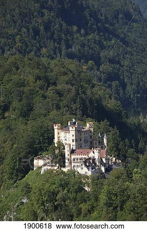 a bavarian castle on a mountain side surrounded by trees; fussen, germany View Large Photo Image Stock Photo - a bavarian castle on a mountain side surrounded by trees; fussen, germany. Fotosearch