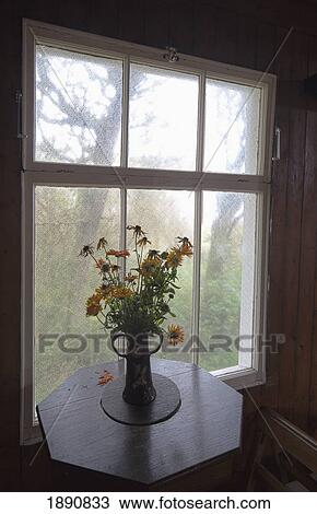 a bouquet of flowers in a vase on a table by the window; northumberland, england View Large Photo Image Stock Image - a bouquet of flowers in a vase on a table by the window; northumberland, england. Fotosearch