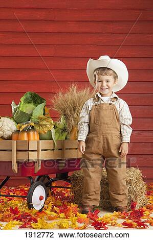 a boy dressed as a farmer with a wagon full of produce; three hills, alberta, canada View Large Photo Image Stock Image - a boy dressed as a farmer with a wagon full of produce; three hills, alberta, canada. Fotosearch