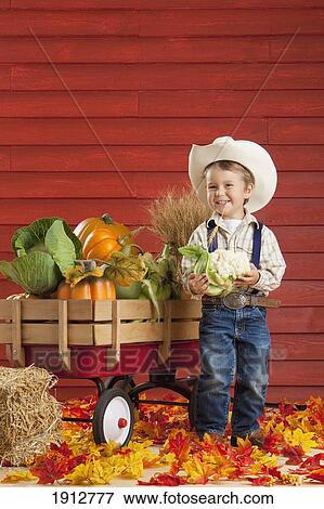 a boy dressed as a farmer with a wagon full of produce; three hills, alberta, canada View Large Photo Image Stock Photo - a boy dressed as a farmer with a wagon full of produce; three hills, alberta, canada. Fotosearch