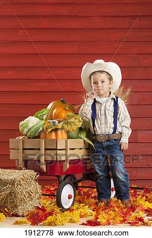 a boy dressed as a farmer with a wagon full of produce; three hills, alberta, canada View Large Photo Image Stock Photo - a boy dressed as a farmer with a wagon full of produce; three hills, alberta, canada. Fotosearch