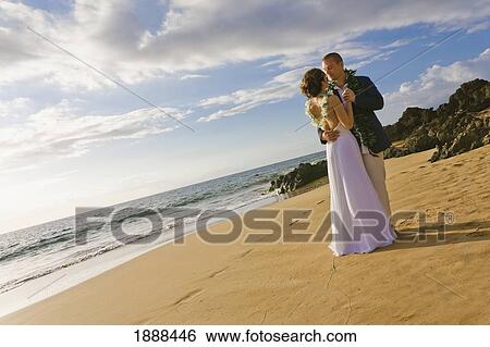 a bride and groom on a beach; maui, hawaii, united states of america View Large Photo Image Stock Photograph - a bride and groom on a beach; maui, hawaii, united states of america. Fotosearch