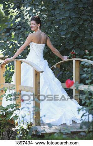 Picture - a bride posing on a bridge; troutdale, oregon, united states of america. Fotosearch