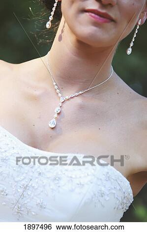 a bride wearing a matching necklace and earring set; troutdale, oregon, united states of america View Large Photo Image Stock Photograph - a bride wearing a matching necklace and earring set; troutdale, oregon, united states of america. Fotosearch