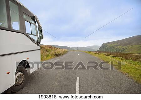 a bus traveling down a road; county wicklow, ireland View Large Photo Image Stock Photo - a bus traveling down a road; county wicklow, ireland. Fotosearch