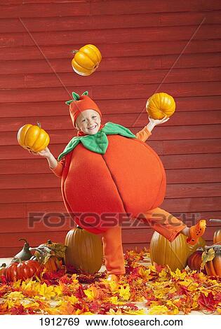 a child in a pumpkin costume juggling pumpkins; three hills, alberta, canada View Large Photo Image Stock Photo - a child in a pumpkin costume juggling pumpkins; three hills, alberta, canada. Fotosearch