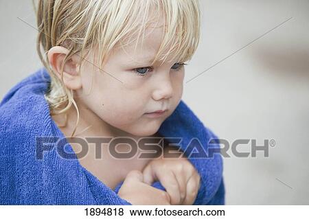 Stock Photo - a child with wet hair wrapped in a towel; currumbin, gold coast, queensland, australia. Fotosearch