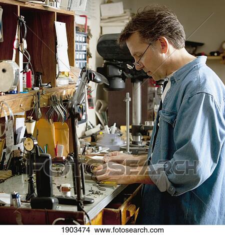 Picture - a clock maker and repairman; st. catharines, ontario, canada. Fotosearch