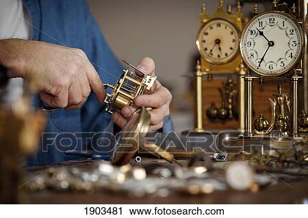 Stock Image - a clock maker and repairman; st. catharines, ontario, canada. Fotosearch