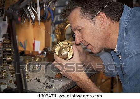 Stock Photo - a clock maker and repairman; st. catharines, ontario, canada. Fotosearch