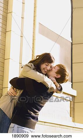 Stock Photo - a couple in an embrace; wilmar, minnesota, united states of america. Fotosearch