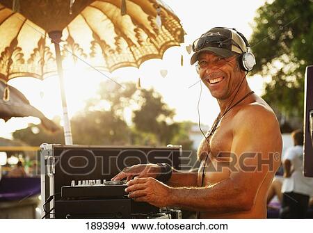 a disc jockey playing music at explora beach bar; tarifa, cadiz, andalusia, spain View Large Photo Image Picture - a disc jockey playing music at explora beach bar; tarifa, cadiz, andalusia, spain. Fotosearch