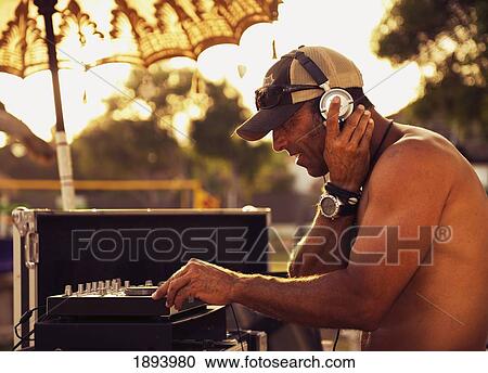a disc jockey playing music at explora beach bar; tarifa, cadiz, andalusia, spain View Large Photo Image Stock Image - a disc jockey playing music at explora beach bar; tarifa, cadiz, andalusia, spain. Fotosearch