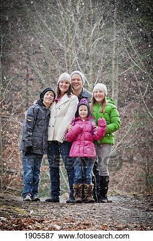 Stock Photo - a family portrait in a snowfall; grimsby, ontario, canada. Fotosearch