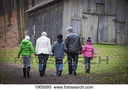 Stock Image - a family walking down a path; grimsby, ontario, canada. Fotosearch