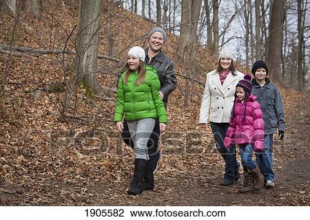 Stock Image - a family walks down a path in autumn; grimsby, ontario, canada. Fotosearch