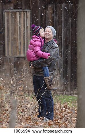 Picture - a father being kissed by his young daughter; grimsby, ontario, canada. Fotosearch