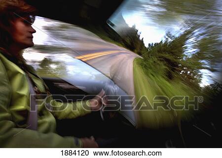 a fatigued woman drives her car down a lonely stretch of highway in glacier national park doing her best to pay attention; montana, united states of america View Large Photo Image Stock Image - a fatigued woman drives her car down a lonely stretch of highway in glacier national park doing her best to pay attention; montana, united states of america. Fotosearch