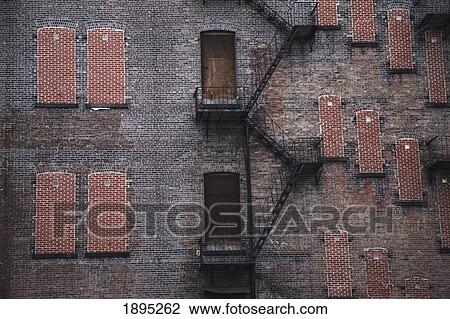 a fire escape going up the side of a brick building; manhattan, new york city, new york, united states of america View Large Photo Image Stock Image - a fire escape going up the side of a brick building; manhattan, new york city, new york, united states of america. Fotosearch