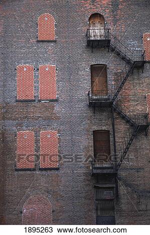 a fire escape going up the side of a brick building; manhattan, new york city, new york, united states of america View Large Photo Image Stock Image - a fire escape going up the side of a brick building; manhattan, new york city, new york, united states of america. Fotosearch