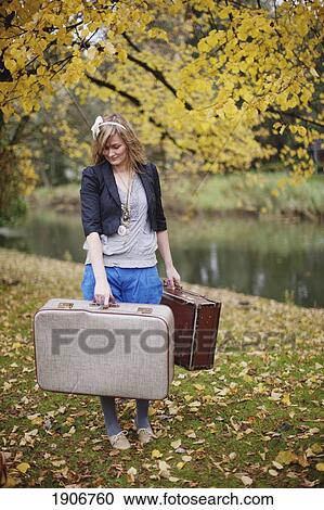 a girl carrying suitcases through a park; amsterdam, the netherlands View Large Photo Image Stock Image - a girl carrying suitcases through a park; amsterdam, the netherlands. Fotosearch