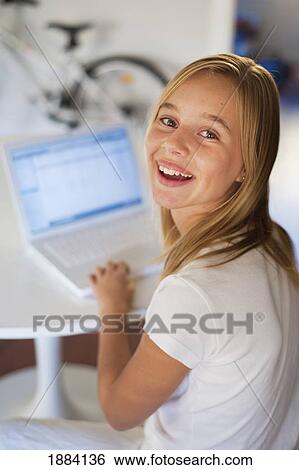 a girl dress in white and using a white laptop computer in a room furnished in white; benalamadena costa, malaga, andalusia, spain View Large Photo Image Stock Photograph - a girl dress in white and using a white laptop computer in a room furnished in white; benalamadena costa, malaga, andalusia, spain. Fotosearch