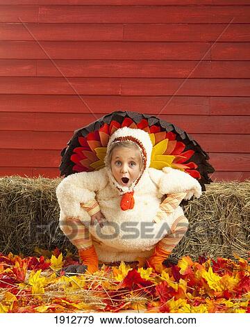 Stock Photo - a girl dressed in a turkey costume; three hills, alberta, canada. Fotosearch