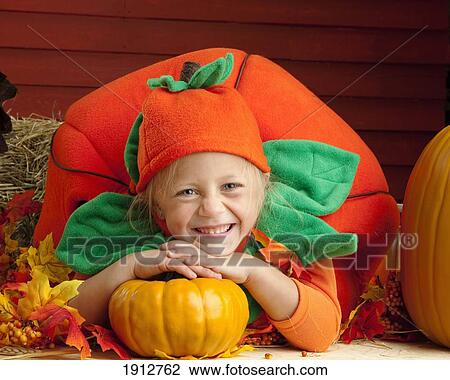 a girl in a pumpkin costume; three hills, alberta, canada View Large Photo Image Stock Image - a girl in a pumpkin costume; three hills, alberta, canada. Fotosearch