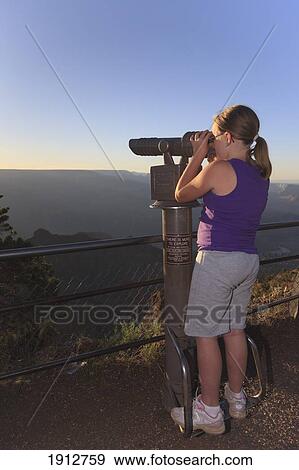 a girl looks into the distance at the grand canyon with binoculars; arizona, united states of america View Large Photo Image Stock Photo - a girl looks into the distance at the grand canyon with binoculars; arizona, united states of america. Fotosearch
