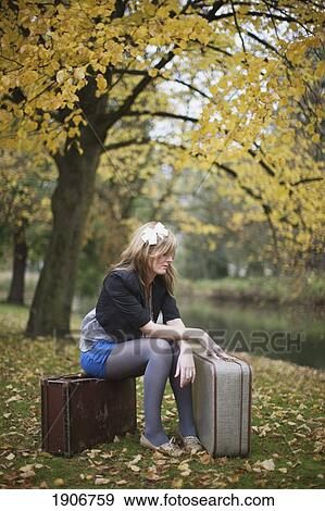 a girl sitting on suitcases in the park; amsterdam, the netherlands View Large Photo Image Stock Photo - a girl sitting on suitcases in the park; amsterdam, the netherlands. Fotosearch