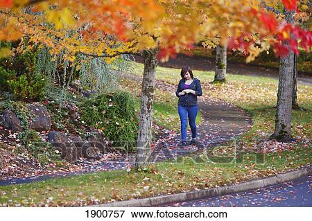 a girl walking along a trail in autumn; portland, oregon, united states of america View Large Photo Image Stock Photo - a girl walking along a trail in autumn; portland, oregon, united states of america. Fotosearch