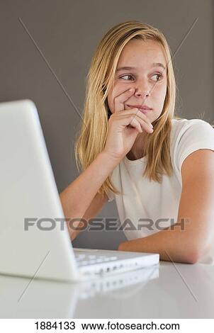 a girl wearing white and using a white laptop computer with a look of contemplation; benalamadena costa, malaga, andalusia, spain View Large Photo Image Stock Image - a girl wearing white and using a white laptop computer with a look of contemplation; benalamadena costa, malaga, andalusia, spain. Fotosearch