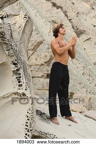 a man doing a yoga pose and meditating in parque natural del estrecho; tarifa, cadiz, andalusia, spain View Large Photo Image Stock Image - a man doing a yoga pose and meditating in parque natural del estrecho; tarifa, cadiz, andalusia, spain. Fotosearch
