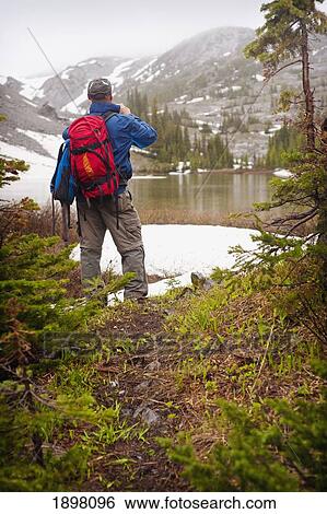 a man hiking through the mountains; fernie, british columbia, canada View Large Photo Image Stock Photograph - a man hiking through the mountains; fernie, british columbia, canada. Fotosearch