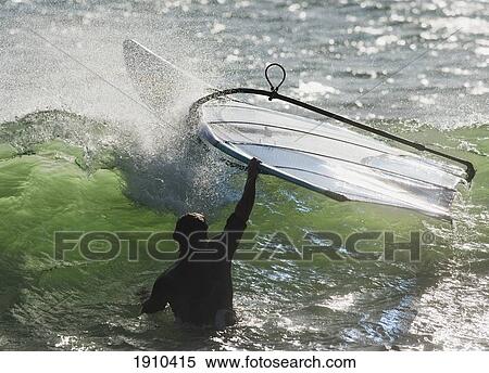 a man in the water holding onto his windsurfing board; tarifa, cadiz, andalusia, spain View Large Photo Image Stock Photography - a man in the water holding onto his windsurfing board; tarifa, cadiz, andalusia, spain. Fotosearch