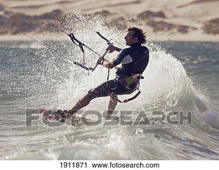 Stock Image - a man kitesurfing; tarifa, cadiz, andalusia, spain. Fotosearch