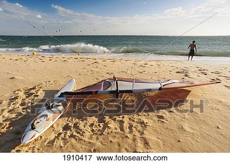 a man on the beach with his windsurfing board; tarifa, cadiz, andalusia, spain View Large Photo Image Stock Photo - a man on the beach with his windsurfing board; tarifa, cadiz, andalusia, spain. Fotosearch