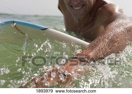 a man paddling on his surfboard off valdevequeros beach; tarifa, cadiz, andalusia, spain View Large Photo Image Stock Photo - a man paddling on his surfboard off valdevequeros beach; tarifa, cadiz, andalusia, spain. Fotosearch