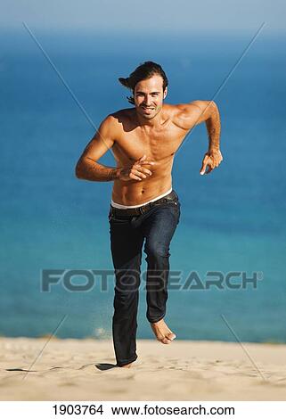 a man running on punta paloma beach; tarifa cadiz, andalusia, spain View Large Photo Image Picture - a man running on punta paloma beach; tarifa cadiz, andalusia, spain. Fotosearch